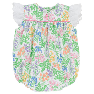 The Beaufort Bonnet Company’s Baby Girls’ Angel Sleeve Blythe Bubble features a colorful floral print, white eyelet lace flutter sleeves inspired by its signature angel sleeve design, and a gathered neckline crafted from soft Pima Cotton, showcased against a white background.