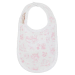The Burp Me Bib - Sir Propers Sweet Arrival by The Beaufort Bonnet Company is a white baby bib adorned with a subtle pink pattern of small animal and object drawings, made from soft Pima cotton. It features a convenient snap closure at the neck, making it a charming addition to any baby gift set.