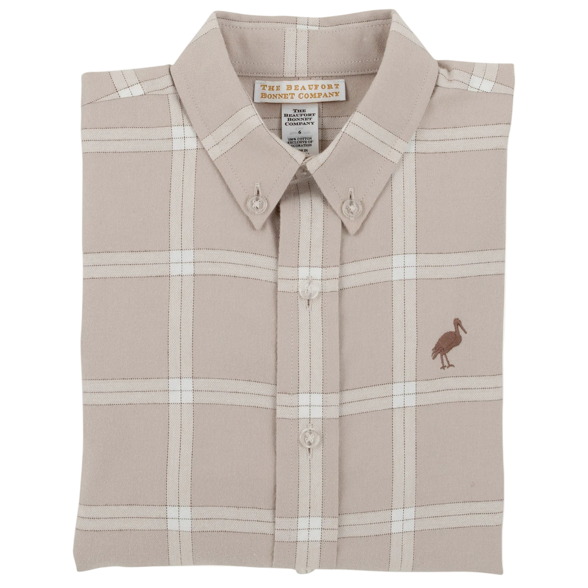 A beige Boys’ Flannel Dean’s List Dress Shirt from The Beaufort Bonnet Company with a pelican logo on the chest, neatly folded with the collar and buttons visible.