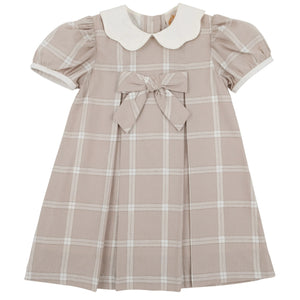 The Beaufort Bonnet Company’s Baby Girls’ and Girls’ Francene Frock is a charming, short-sleeved beige Thompson Park Plaid dress featuring a white Peter Pan collar, front bow detail, and pleated skirt—perfectly designed for young children.