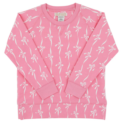 Baby Girls’ and Girls’ French Terry Cassidy Comfy Crewneck from The Beaufort Bonnet Company, shown in pink with a delightful Bow Print pattern of white bows and ribbons, displayed flat with the long sleeves crossed over the front.