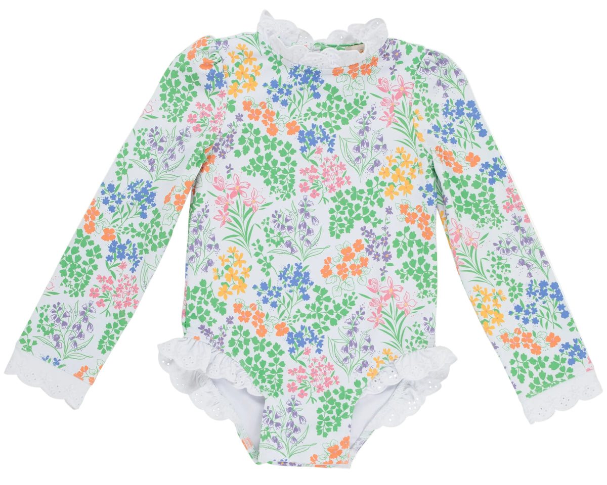 A long-sleeve Sarasota Surf Suit for baby girls by The Beaufort Bonnet Company, featuring elegant floral patterns and delicate lace trim on the collar, cuffs, and leg openings, inspired by timeless classic style.