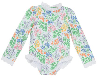 A long-sleeve Sarasota Surf Suit for baby girls by The Beaufort Bonnet Company, featuring elegant floral patterns and delicate lace trim on the collar, cuffs, and leg openings, inspired by timeless classic style.