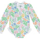 The Baby Girls’ and Girls’ Sarasota Surf Suit by The Beaufort Bonnet Company features long sleeves and a charming floral print in green, orange, purple, and pink. Detailed with a white bow at the collar and delicate lace trim on the sleeves and leg openings, this sweet style adds classic charm to your little one’s wardrobe.