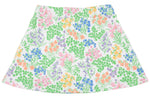 The Girls’ Searcy Skort by The Beaufort Bonnet Company features an A-line silhouette with a white base adorned with a vibrant floral pattern showcasing green leaves and pink, blue, orange, and purple flowers, all crafted from soft and durable Pima Cotton for lasting comfort.