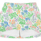 The Girls’ Searcy Skort by The Beaufort Bonnet Company is a white skort made from soft Pima Cotton, showcasing a vibrant floral pattern in shades of green, orange, pink, and blue. It features an elastic waistband and built-in white shorts for comfort and style.