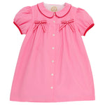 This charming dress—featuring short sleeves, a button-front design, Peter Pan collar, red trim, and two small red bows on the chest—resembles The Beaufort Bonnet Company’s Baby Girls’ and Girls’ Tabitha’s Teacher’s Pet Dress in their signature Hamptons Hot Pink.