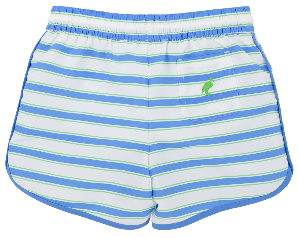 The Beaufort Bonnet Company’s Baby Boys’ and Boys’ Tanner Trunks feature a Seabrook Stripe pattern in blue, white, and green, an elastic waistband, a back pocket adorned with a small green pelican logo, and blend comfort with timeless style.