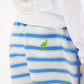 A close-up of a person wearing The Beaufort Bonnet Company’s Baby Boys’ and Boys’ Tanner Trunks in the Seabrook Stripe pattern—blue, green, and white striped shorts featuring a green bird embroidered on the back pocket.