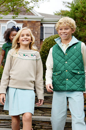 Two children wearing light blue and Saratoga Gate Green outfits, including the Baby Boys’ and Boys’ Vaughn Vest by The Beaufort Bonnet Company, walk outside together smiling, while another child stands in the background near a house.