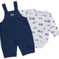 Dress your little one in the Kissy Kissy Baby Boys’ Bears on the Go Overall Set, crafted from soft Pima cotton and featuring navy blue overalls paired with a white long-sleeve onesie adorned with playful blue and yellow truck and bear illustrations.