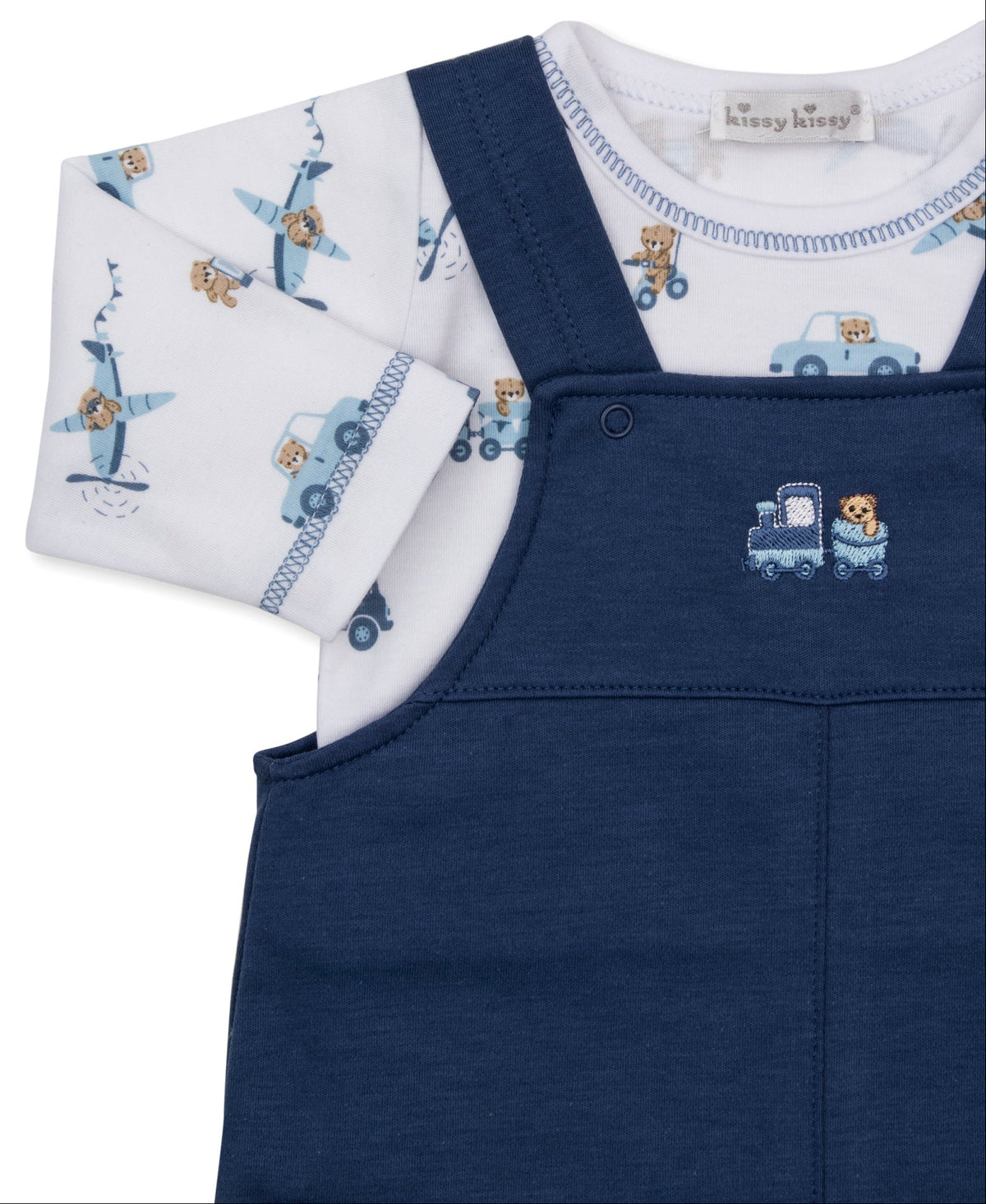 Outfit your baby boy in the Kissy Kissy Baby Boys’ Bears on the Go Overall Set. This charming ensemble features soft Pima cotton blue overalls with an embroidered blue train and bear on the chest, layered over a white long-sleeve shirt adorned with playful teddy bears, blue airplanes, and cars.