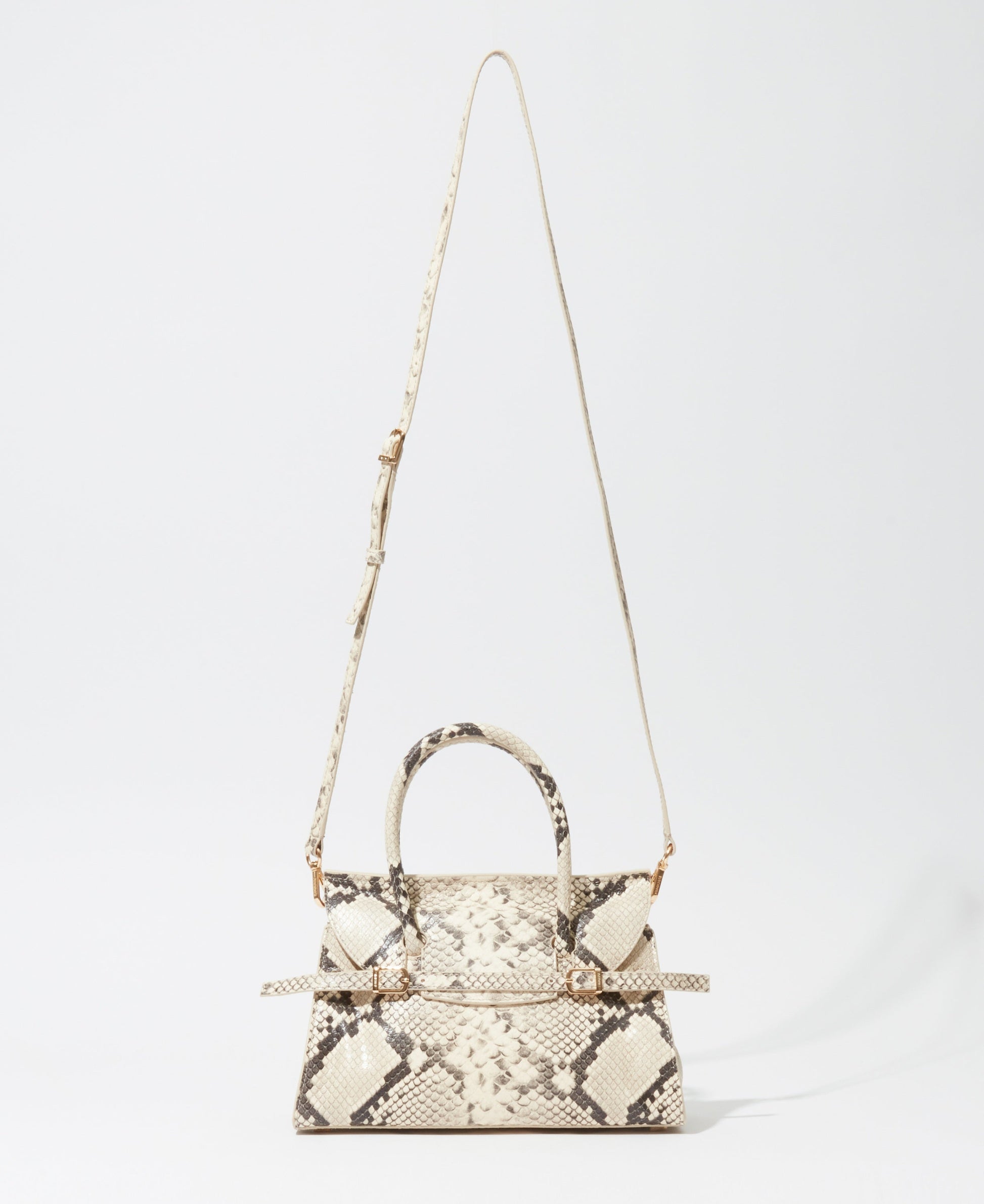 The Simkhai River Small Snake Top Handle Bag features a beige and brown snakeskin pattern, top handles, and a long adjustable shoulder strap, shown against a plain white background.