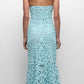 A woman facing away wears the Simkhai Clairis Lace Bustier Midi Dress in light blue, featuring a strapless bodice and flared hem, styled with beige heeled sandals.