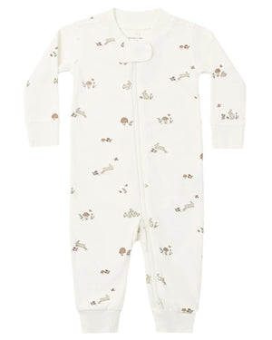 The Quincy Mae Baby Zip Long Sleeve Sleeper is a white onesie made from soft organic brushed jersey, featuring a diagonal zipper and a subtle pattern of small woodland animals and mushrooms in muted tones.