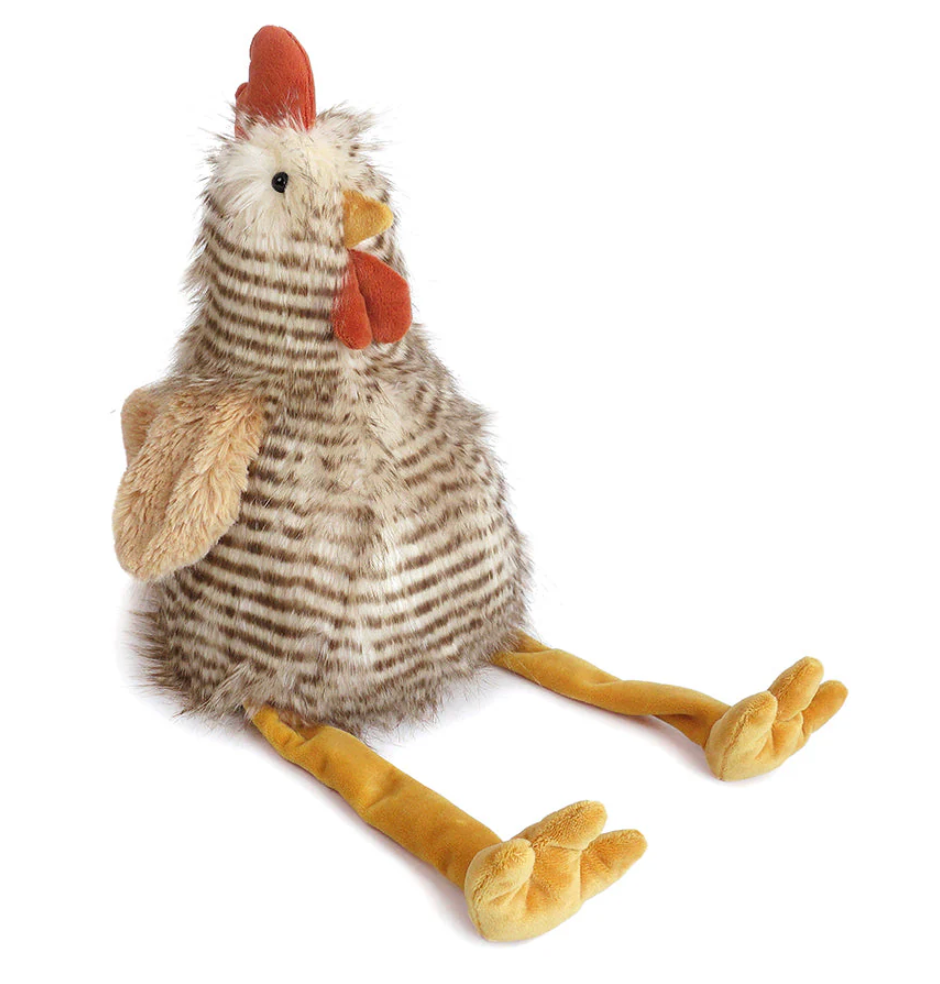 Chester Chicken by Mon Ami is a plush toy featuring striped faux fur, an orange beak, comb, wattles, and long yellow legs, shown sitting upright on a white background.