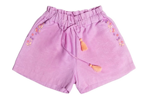 The Early Sunday Girls’ Roman Shorts, shown in light purple on a white background, feature an elastic waistband with a tassel drawstring and delicate embroidered floral accents along the sides. These comfortable cotton linen shorts are designed with a relaxed fit for all-day wear.