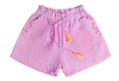 The Early Sunday Girls’ Roman Shorts, shown in light purple on a white background, feature an elastic waistband with a tassel drawstring and delicate embroidered floral accents along the sides. These comfortable cotton linen shorts are designed with a relaxed fit for all-day wear.