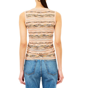A person is shown from the back against a white background wearing the Ulla Johnson Alisa Knit Top, a slim fit beige patterned knit, paired with blue jeans.