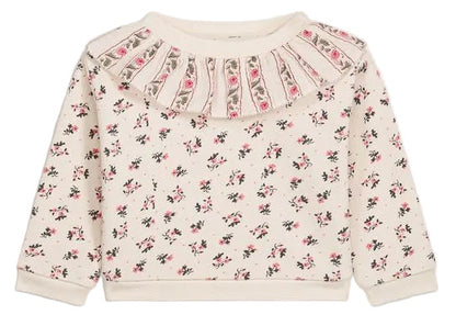 The Louise Misha Baby Girls’ Rosaline Sweatshirt is a long-sleeve, cream-colored piece for toddlers, featuring a ruffle neckline, pleated details, and delicate pink floral accents for a soft, charming look.