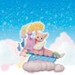 A Calico Critters figurine rides the pastel-colored Daydream Parade Playset—a whimsical toy train with wings and clouds—set against a background of stars and fluffy clouds.