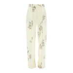 The Victoria Beckham Floral Wide Leg Trouser features a cream color, high-rise fit, straight-leg cut, and a black/off white floral and landscape print.