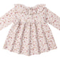 The Quincy Mae Baby Girls' and Girls' Ruffle Collar Jersey Dress features long sleeves, a floral print in light pink and beige, front buttons, a ruffled collar, and comes with matching bloomers for easy dressing.