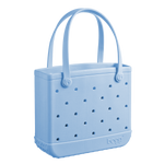 The Baby Bogg Bag by Bogg Bags is a light blue tote with two handles, ventilation holes, and "bogg" embossed near the bottom. This washable bag is practical and stylish for everyday use.