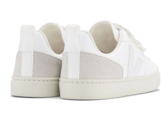 The back view of the Veja Kids' V-10 Velcro CWL Sneaker by Veja, featuring white casual sneakers made from organic cotton with light gray vegan suede accents on the heel.