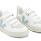 The Veja Kids' V-10 Velcro CWL Sneaker by Veja is a stylish pair of white sneakers with light grey and green accents. They feature two velcro straps, perforated detailing on the toe area, and are crafted from organic cotton and Amazonian rubber.