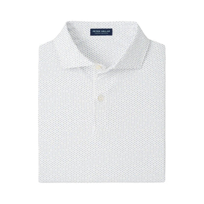 The Fermata Performance Jersey Polo by Peter Millar is a white collared shirt with a subtle blue dotted pattern, two buttons, and four-way stretch for comfort. "Peter Millar" is featured on the inside collar tag.