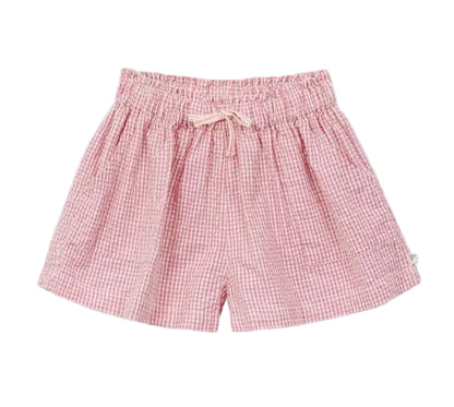 The Arsene & Les Pipelettes Girls' Vichy Short features pink gingham seersucker fabric, an elastic waistband with a drawstring tie, and convenient side pockets—perfect for sunny days, shown here on a white background.