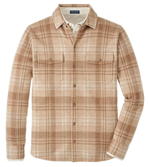 The Peter Millar Gordon Plaid Sweater Shirt Jacket features a beige and light brown plaid Merino wool, two chest pockets, and is a versatile, minimal layer—perfect for any wardrobe. Displayed against a white background.