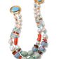 The Ariel Necklace by Lizzie Fortunato is a double-strand statement piece with assorted beads—freshwater pearls, turquoise, jade, coral, and gold accents—finished with round gold clasps set with turquoise stones.