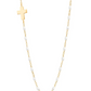 The Gigi Clozeau Side Cross Necklace 16.5" by Gigi Clozeau features small resin pearls and a side cross pendant, crafted in 18 carat gold for a timeless design.