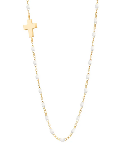 The Gigi Clozeau Side Cross Necklace 16.5" by Gigi Clozeau features small resin pearls and a side cross pendant, crafted in 18 carat gold for a timeless design.