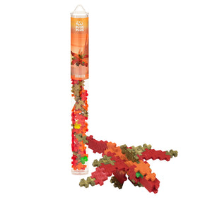 The Plus-Plus Tube - Dragon by Plus Plus is shown with a completed dragon model in red, orange, green, and brown interlocking pieces—ideal for creative play that encourages fine motor skill development.