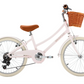 A light pink Banwood Kids’ Vintage Classic Bike featuring a brown leather seat, white tires, a wicker basket mounted on the front, and a small bell on the handlebars—perfectly embodying timeless Scandinavian design in a charming, child-friendly style.