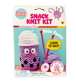 Bright Stripes Snack Knit Kit – Boba Buddy: Create a fun boba-themed craft with this beginner-friendly knitting kit, ideal for young enthusiasts or craft clubs! Includes purple yarn, knitting needles, and simple instructions. Suitable for ages 8+. The front of the package displays an image of the finished project.