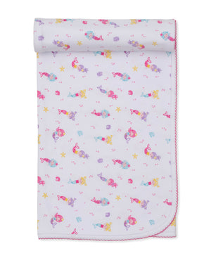 The Kissy Kissy Underwater Mermaid Blanket is a light purple cozy blanket adorned with a vibrant cartoon mermaid design, decorated with starfish and seashell patterns, and finished with pink stitching along the edges.