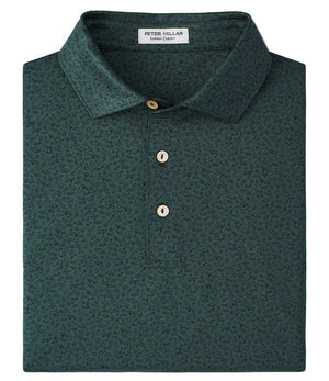 The Peter Millar No Slow Play Performance Jersey Polo is a dark green, short-sleeve polo with a subtle pattern, three buttons, and an inside collar label, crafted for four-way stretch and UPF 50+ protection.