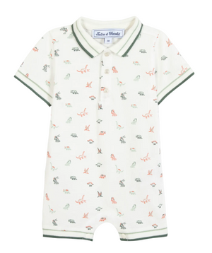 The Tartine et Chocolat Baby Boys’ Short Jumpsuit is a short-sleeve cotton romper with a collar and button placket, featuring a playful dinosaur illustration and green trim on the sleeves, collar, and leg openings.