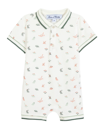 The Tartine et Chocolat Baby Boys’ Short Jumpsuit is a short-sleeve cotton romper with a collar and button placket, featuring a playful dinosaur illustration and green trim on the sleeves, collar, and leg openings.