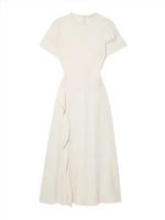 The Ulla Johnson Cassia Dress is a cream-colored, short-sleeve, ankle-length masterpiece with a fitted bodice and an asymmetric draped detail on the skirt. Made from luxurious crepe de chine fabric, it features a sophisticated high neckline for an elegant touch.