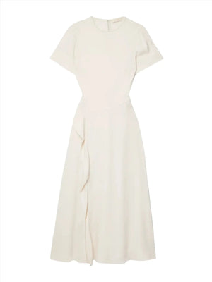 The Ulla Johnson Cassia Dress is a cream-colored, short-sleeve, ankle-length masterpiece with a fitted bodice and an asymmetric draped detail on the skirt. Made from luxurious crepe de chine fabric, it features a sophisticated high neckline for an elegant touch.