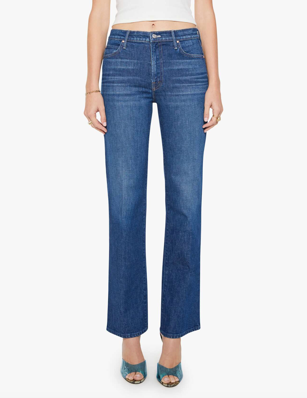 Model wears the Kick It high-rise straight-leg jeans in mid-blue recycled stretch denim by Mother, paired with teal open-toe heels. Waist to feet shown against a plain white background.
