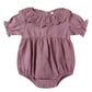 The Quincy Mae Baby Girls' Collared Romper features mauve fabric, puff sleeves, a ruffled collar, gathered waist, and handy snap closures at the bottom.
