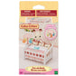 The Calico Critters Crib with Mobile comes in packaging and features a crib with an attached mobile, along with three small animal figures. This adorable baby nursery set from Calico Critters includes dollhouse furniture perfect for imaginative play. The packaging displays warnings and is recommended for ages 3 and up.