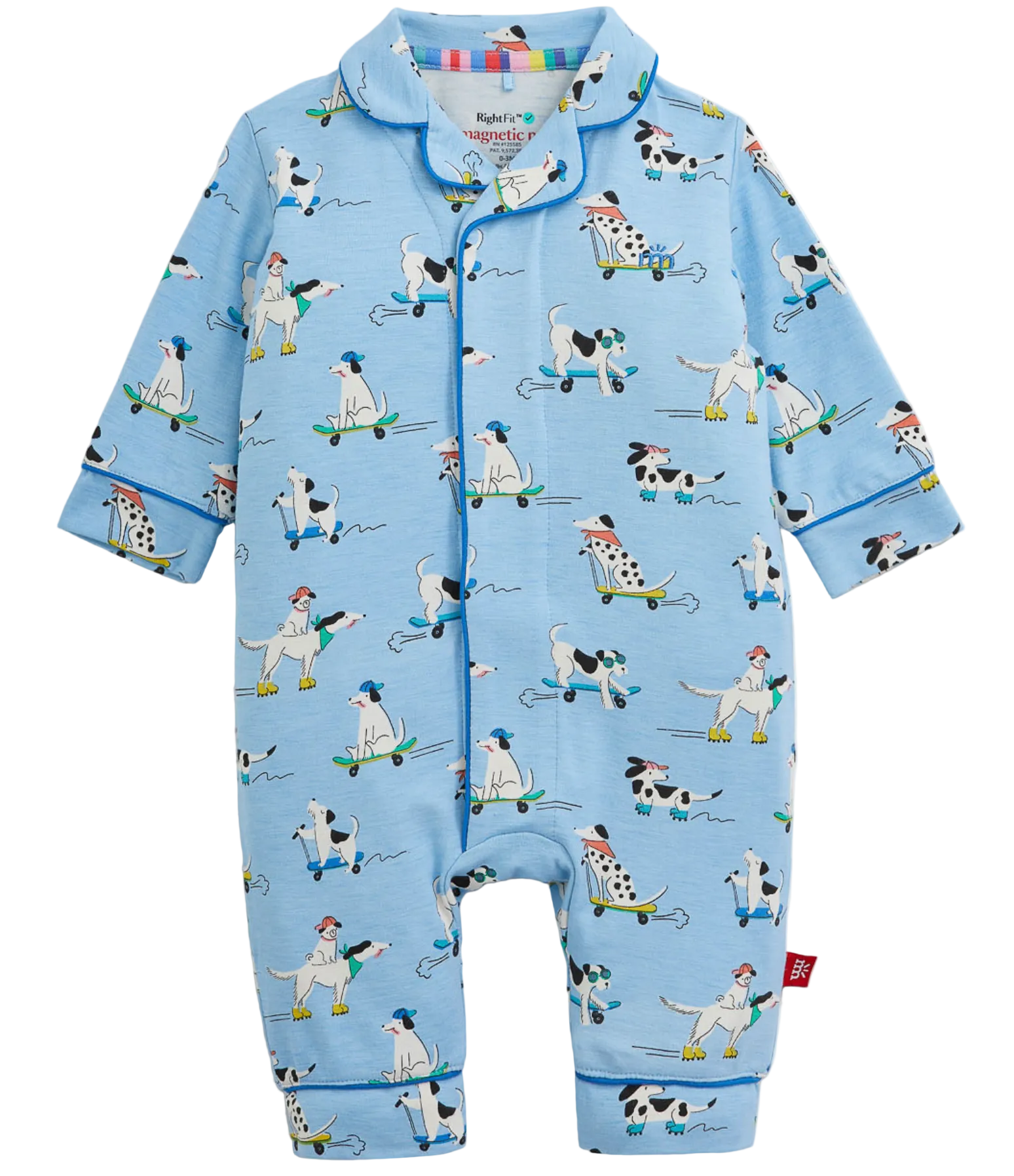 The Magnetic Me Baby Boys’ Ruff Riders Coverall features a light blue design with playful cartoon dogs on skateboards, each wearing hats and bandanas. Trimmed with blue piping along the edges, this coverall is crafted from naturally flame resistant RightFit fabric for extra peace of mind.