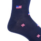 Close-up of a Dapper Classics navy sock in mercerized cotton, showcasing a pattern of small American flags. Crafted with breathable material and designed for a comfortable mid-calf fit, perfect for all-day wear.